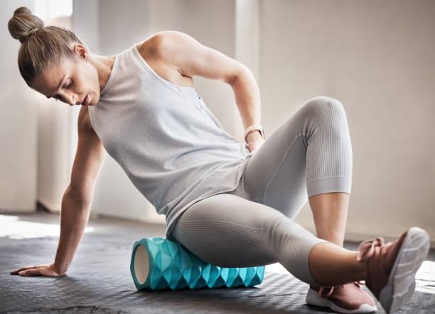Woman using a foam roller for core mobility training to enhance flexibility and prevent injuries.