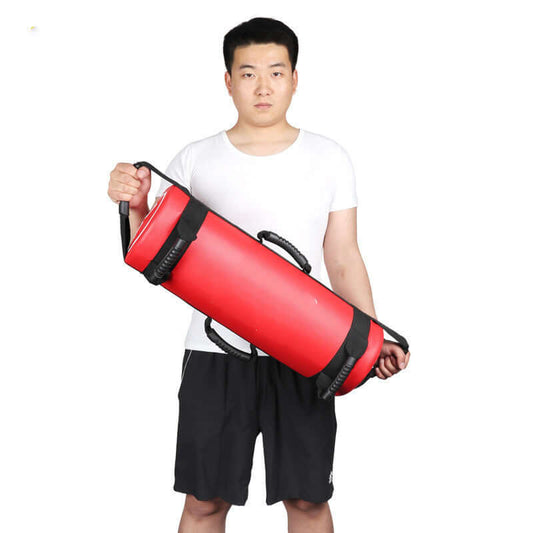 Man holding a red Weight Bearing Fitness Energy Pack for strength and endurance training.