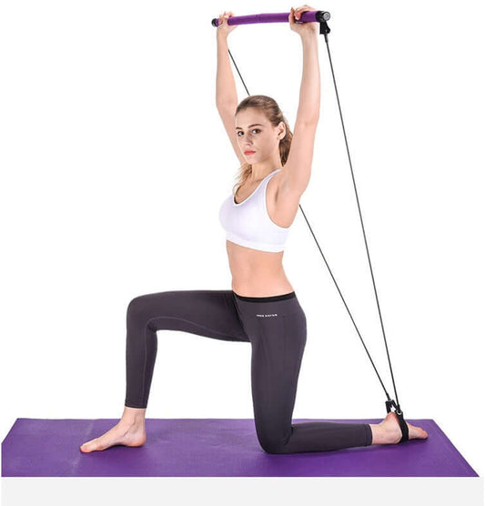 Young woman using yoga resistance bands on a purple mat to enhance strength and flexibility.