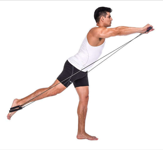 Man using yoga resistance bands for strength training and flexibility exercises in a workout setting.