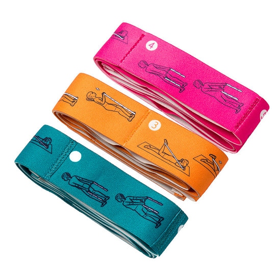 Yoga stretch bands in pink, orange, and teal for resistance training and flexibility exercises.